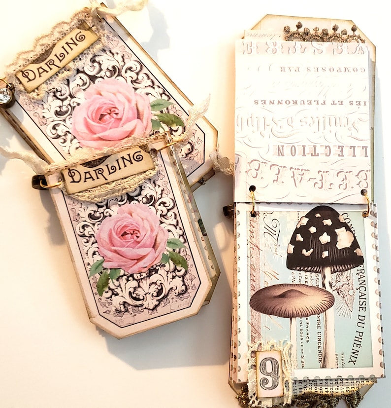 May include: Two decorative tags with a floral design and the word "Darling" on each. The tags are attached to a larger tag with a mushroom illustration and the text "FRAN&Ccedil;AISE DU PHENIX".
