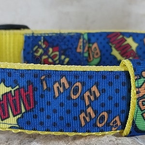May include: A blue dog collar with yellow trim and a comic book print featuring words like "Bark!" and "I'm Awesome!"