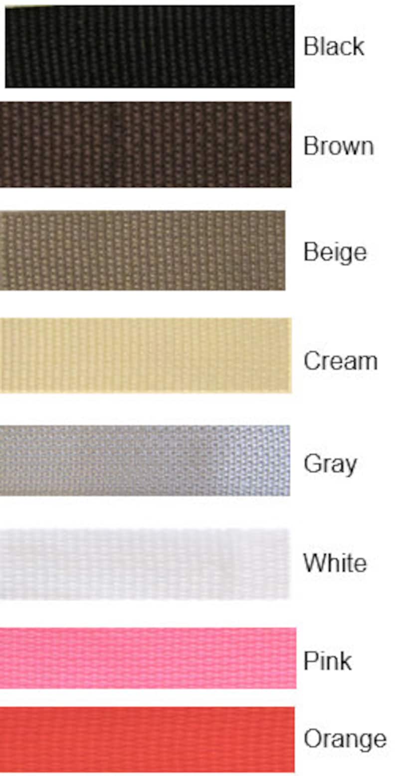 May include: A swatch card displaying eight different fabric colours: black, brown, beige, cream, grey, white, pink, and orange.