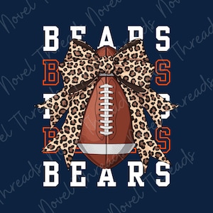 May include: A graphic design featuring a brown American football centered behind a large leopard print bow. The word BEARS is printed in white block letters above and below the football, with orange BEARS text on the left and right sides.