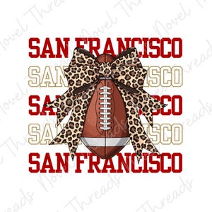 May include: A football with a leopard print bow, and the words "SAN FRANCISCO" in red and gold. The football is brown with white stripes and laces. The background is white.
