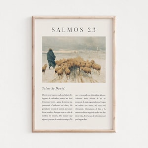 May include: A framed print with a pastoral scene of a shepherd and sheep, with Spanish text. The artwork is set against a neutral background, and the frame is a light wood colour. The text reads "SALMOS 23".