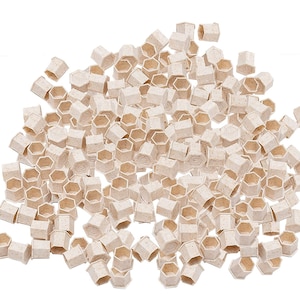 May include: A large pile of small, beige, hexagonal-shaped plastic containers. The containers are made of a textured material and have a slightly raised lip around the top edge.