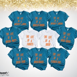 May include: A collection of teal and white t-shirts with orange text. The shirts have phrases like "The Life of a Bride," "Maid of Honor," and "Bride Tribe." The shirts are for a bridal party. The background has gold glitter.