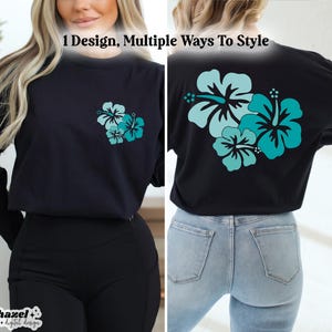 May include: A black long-sleeved t-shirt with a teal hibiscus flower design on the front and back. The text "1 Design, Multiple Ways To Style" is printed on the shirt.