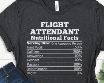 May include: A dark grey t-shirt with a white graphic that reads "FLIGHT ATTENDANT Nutritional Facts" and lists various job requirements as percentages.