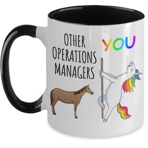 May include: White ceramic mug with a black handle and interior. The mug features the text "OTHER OPERATIONS MANAGERS" and "YOU" in rainbow colors. A brown horse and a unicorn are also depicted.