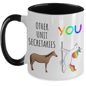 May include: White coffee mug with a black handle and black rim. The mug has a graphic of a unicorn with a rainbow mane and tail, and a brown horse. The text on the mug reads "Other Unit Secretaries You".