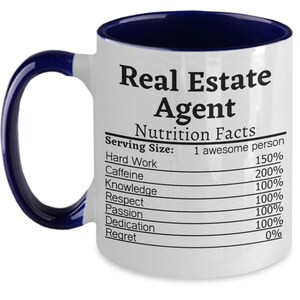 May include: White ceramic coffee mug with a blue rim. The mug has a graphic of a nutrition facts label with the text "Real Estate Agent" and a list of qualities with percentages.