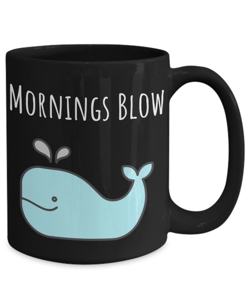 May include: Black coffee mug with a white whale graphic and the text "Mornings Blow".