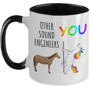 May include: White ceramic mug with a black handle and interior. The mug features the text "OTHER SOUND ENGINEERS" and "YOU" in rainbow colors. A brown horse and a unicorn are also depicted.