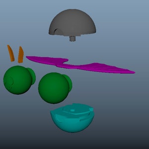 May include: A 3D digital model of a disassembled toy figure featuring a gray dome-shaped head piece, two green spherical body parts, a pair of orange pointed ears, a purple wing-like attachment, and a teal base component with internal slots.