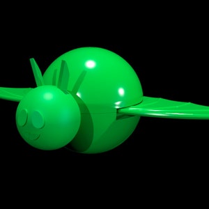 May include: A bright green plastic toy shaped like a stylized insect or creature with a round body, a smaller round head, two pointed antennae, and two wide, flat wings extending from the sides. The surface is smooth and uniform in color.
