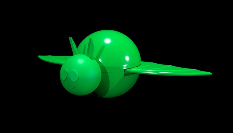 May include: A bright green plastic toy shaped like a stylized insect or creature with a round body, a smaller round head, two pointed antennae, and two wide, flat wings extending from the sides. The surface is smooth and uniform in color.