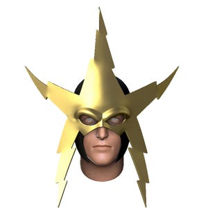 May include: A gold-coloured star-shaped mask with lightning bolt points, covering the eyes and forehead. The mask is worn over a black head covering, with a human face visible below. The mask has a metallic sheen.