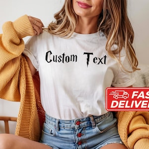 May include: White t-shirt with the text "Custom Text" in a black, stylized font. A red rectangle with the words "Fast Delivery" is in the lower right corner. The person is wearing a yellow cardigan and blue denim shorts.