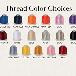 May include: An image showcasing a selection of thread color choices. The image displays spools of thread in various colors, including royal blue, navy blue, neon orange, neon red, lilac, purple, burgundy, white, beige, grey, silver, black, light blue, yellow, dark yellow, light pink, and red.