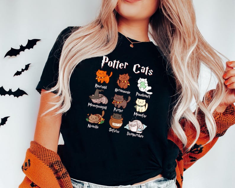 May include: Black t-shirt with a graphic of cats representing characters from the Harry Potter series. The text "Potter Cats" is printed above the graphic.