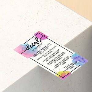 May include: A colorful decal application instruction card with a watercolor background. The card includes instructions on how to apply the decal, including cleaning the surface, removing the backing paper, and smoothing out any bubbles.