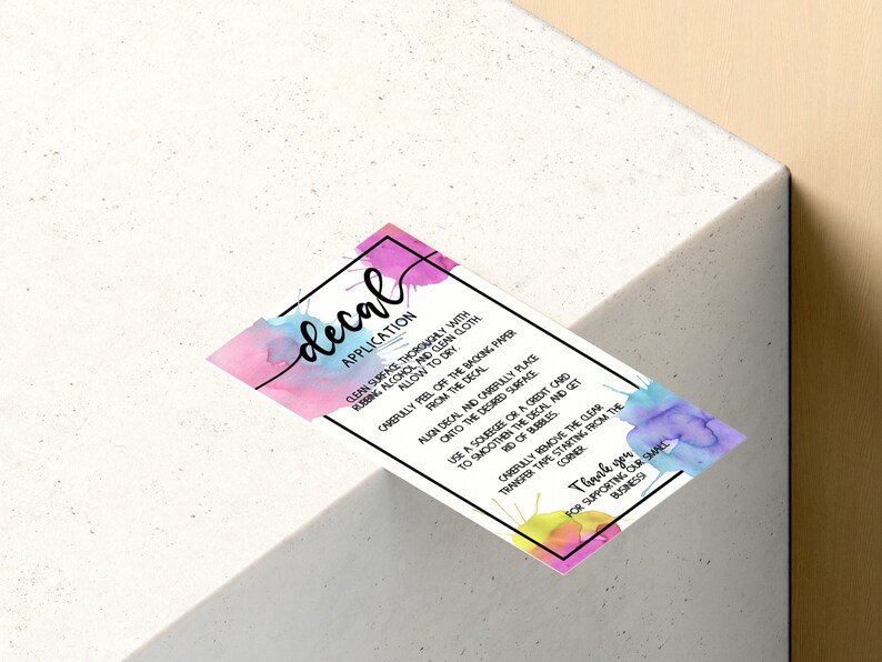 May include: A colorful decal application instruction card with a watercolor background. The card includes instructions on how to apply the decal, including cleaning the surface, removing the backing paper, and smoothing out any bubbles.