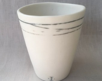 Handmade White Porcelain Mug with Altered Rim and Hand Painted Soft Grey Design