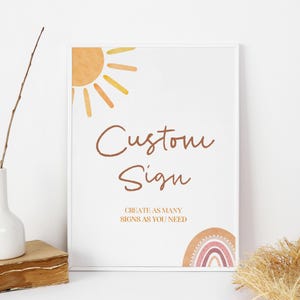 May include: White framed print with a watercolor design. The print features a sun and rainbow illustration with the words "Custom Sign" in brown script. The text "Create as many signs as you need" is also included.