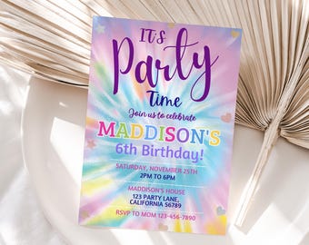 May include: A colourful tie-dye invitation for a 6th birthday party. The invitation features the text "It's Party Time" in purple and "Join us to celebrate Maddison's 6th Birthday!" in rainbow colours. The invitation also includes the date, time, and location of the party.