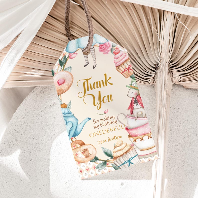 May include: A light brown thank you tag featuring a watercolour illustration of Alice in Wonderland characters and tea party elements. The text reads "Thank You for making my birthday ONEderful Love Andrea".