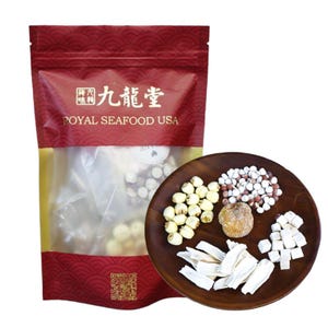 May include: A red and gold bag with the text "九龍堂 ROYAL SEAFOOD USA" on the front. The bag contains a variety of dried ingredients, including lotus seeds, job's tears, and white fungus. The ingredients are also displayed on a wooden plate.