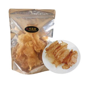 May include: A clear, metallic bag filled with dried, translucent seafood, alongside a white plate holding similar pieces. The bag has a logo with Chinese characters and the text "Royal Seafood USA". The seafood appears golden brown.