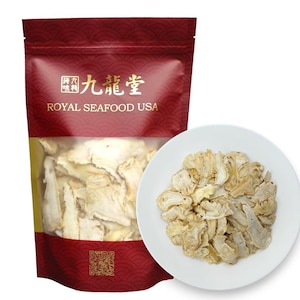 May include: A red and gold bag with the text "九龍堂 ROYAL SEAFOOD USA" on the front. The bag contains dried, white, sliced ginseng root. A white plate with more dried ginseng root is in the foreground.
