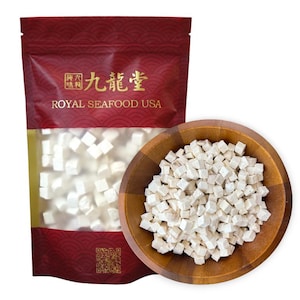 May include: A white bag with red and gold accents and the text "九龍草" and "ROYAL SEAFOOD USA". The bag contains white, cubed, dried ingredients. A wooden bowl filled with the same white, cubed, dried ingredients.