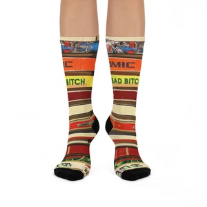 May include: A pair of colourful socks with a striped pattern featuring the text "Bad Bitch" and "Comic".