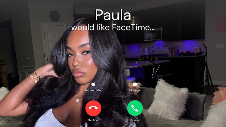 May include: A screenshot of a FaceTime call from Paula. The screen displays a woman with long, dark hair, wearing a white top. The call interface shows "Paula would like FaceTime..." with decline and accept buttons.
