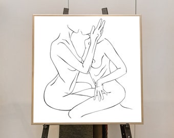 May include: A minimalist line art print featuring two figures in an embrace. The black and white artwork depicts two people in a seated position, with one figure's hand gently touching the other's face. The artwork is displayed on a wooden easel.