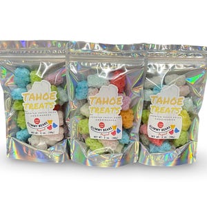 May include: Three bags of freeze-dried gummy bears in assorted colors. Each bag has a label that says "Tahoe Treats" and "Gummy Bears". The bags are made of iridescent silver foil.