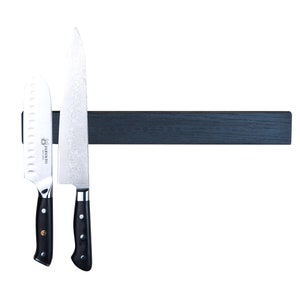May include: A black magnetic knife holder with two silver knives attached. The knives have black handles and the larger knife has the text "Kikuichi" on the side.