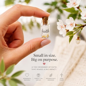 May include: A miniature clear glass bottle with a cork stopper containing small white and yellow beads. The label on the bottle features the word faith in black script. Text on the image reads Small in size. Big on purpose. A tiny reminder of faith.