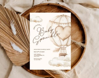 May include: A baby sprinkle invitation card with a hot air balloon illustration and the text "Join us for a Baby Sprinkle". The card features a heart-shaped design and cloud accents, with details for the event.