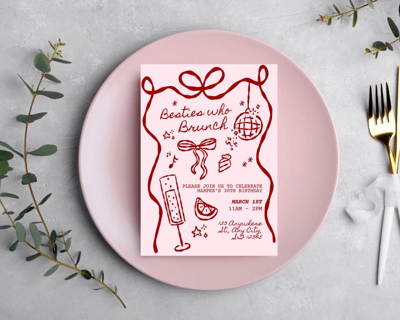 May include: A pink invitation card with the text "Besties who Brunch" in a handwritten style, with illustrations of a disco ball, champagne flute, and cake. The invitation is on a pink plate with a gold fork and white napkin.