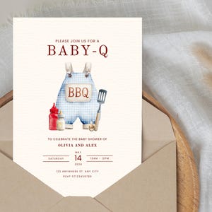 May include: A baby shower invitation with a watercolor design. The invitation features the text "BABY-Q" and an illustration of blue gingham overalls with the word "BBQ". Additional text includes the date, time, and RSVP information.
