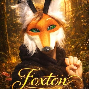 May include: A vibrant orange and white fox mask with green eyes and black accents. The mask has a furry texture and is worn with a black hooded garment. The word "Foxton" is written in gold script.