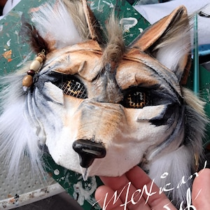 This is a Mexican Wolf. He has a soft gentle expression alongside his noble wolf appearance.  He has bangs that flow down the front of his forehead like a faux hawk, plenty of fluffy fur, charms, and the most realistic and beautiful brownish golden eyes. He has a cute little black nose and interesting patterns that are unique to the Mexican wolf like 3D eyebrows and layered sculpted cheekbones. Order Moxie the Mexican wolf today, you will adore this theriotype