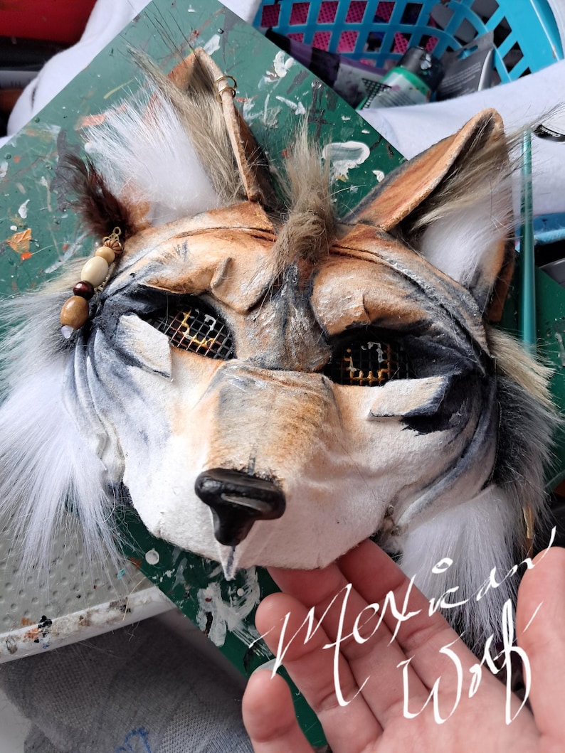 This is a Mexican Wolf. He has a soft gentle expression alongside his noble wolf appearance.  He has bangs that flow down the front of his forehead like a faux hawk, plenty of fluffy fur, charms, and the most realistic and beautiful brownish golden eyes. He has a cute little black nose and interesting patterns that are unique to the Mexican wolf like 3D eyebrows and layered sculpted cheekbones. Order Moxie the Mexican wolf today, you will adore this theriotype