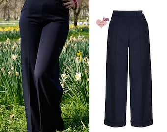 May include: A pair of wide-leg, high-waisted pants in a dark navy blue color. The pants have a cuffed hem and a center crease down the front.