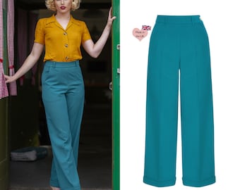 May include: Teal wide-leg pants with a high waist and cuffed hems. Made in the UK.