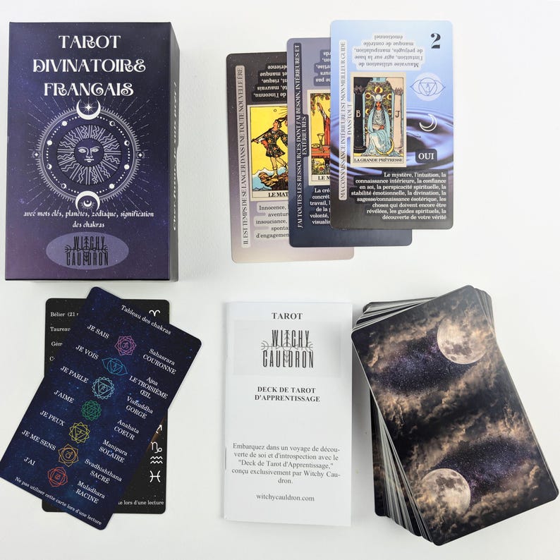 May include: A tarot card deck with a box and several cards. The box is dark purple with the text "TAROT DIVINATOIRE FRAN&Ccedil;AIS" and a sun and moon design. The cards feature illustrations and text in French.