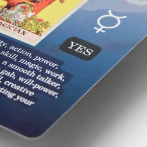 May include: A blue card with the word "YES" in a black circle. The card also has a white astrological symbol for the planet Venus and text that reads "AGICIAN. ty, action, power, skill, magic, work, a smooth talker, gab, will-power, creative ting your"