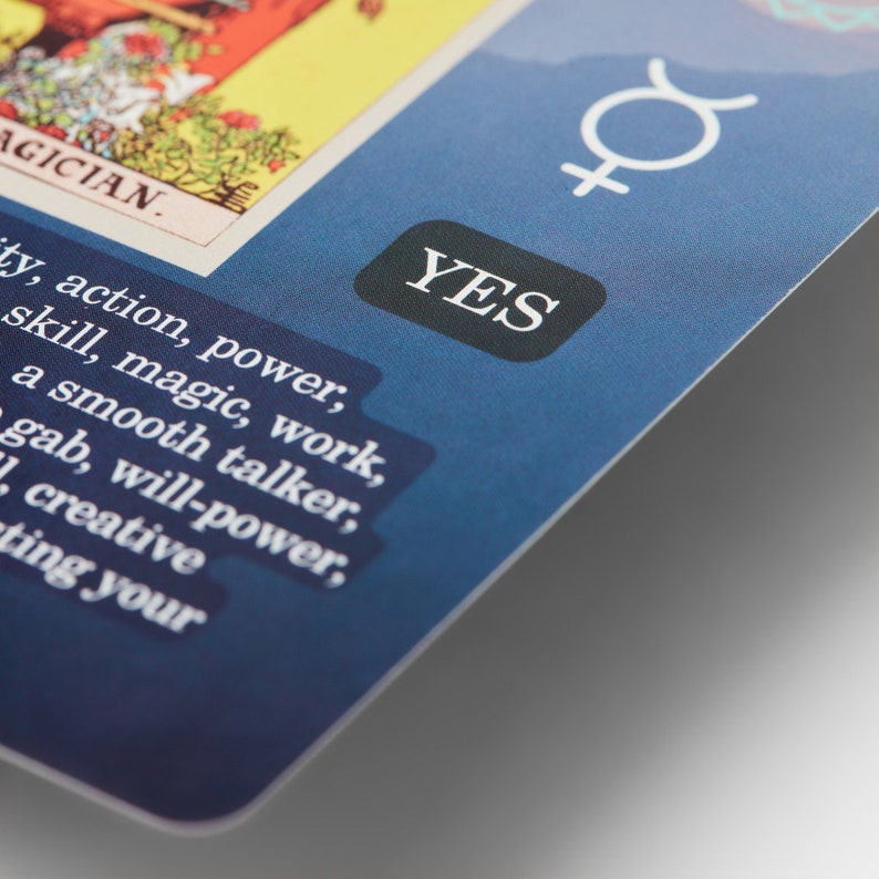 May include: A blue card with the word "YES" in a black circle. The card also has a white astrological symbol for the planet Venus and text that reads "AGICIAN. ty, action, power, skill, magic, work, a smooth talker, gab, will-power, creative ting your"