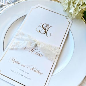 Elegant lace ribbon tied around a wedding menu adds a romantic and refined touch to the table setting. The soft floral texture complements classic stationery and makes your celebration feel even more luxurious and thoughtful.